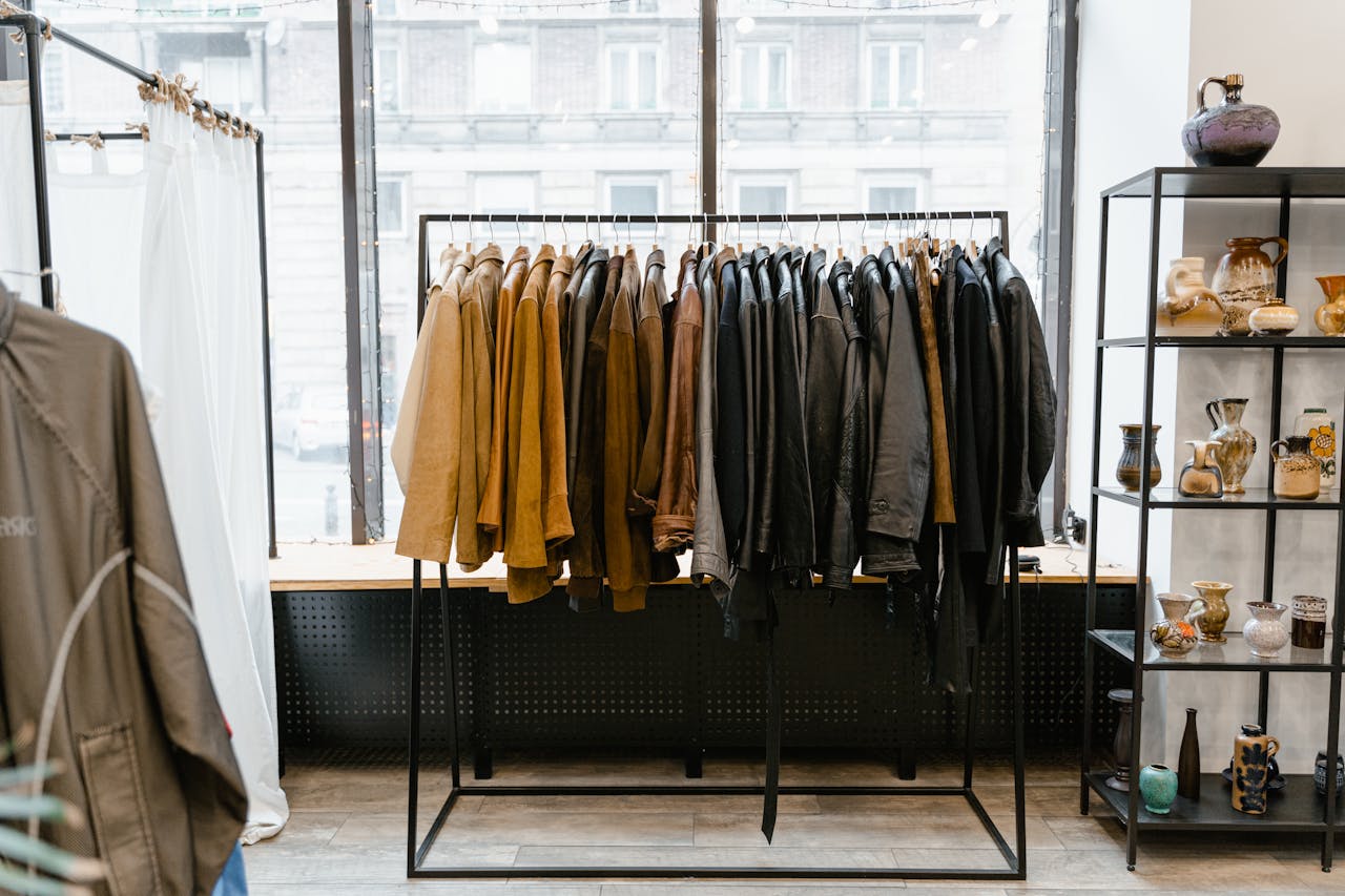 Stylish clothing store interior with jackets on a rack, creating a modern boutique atmosphere.